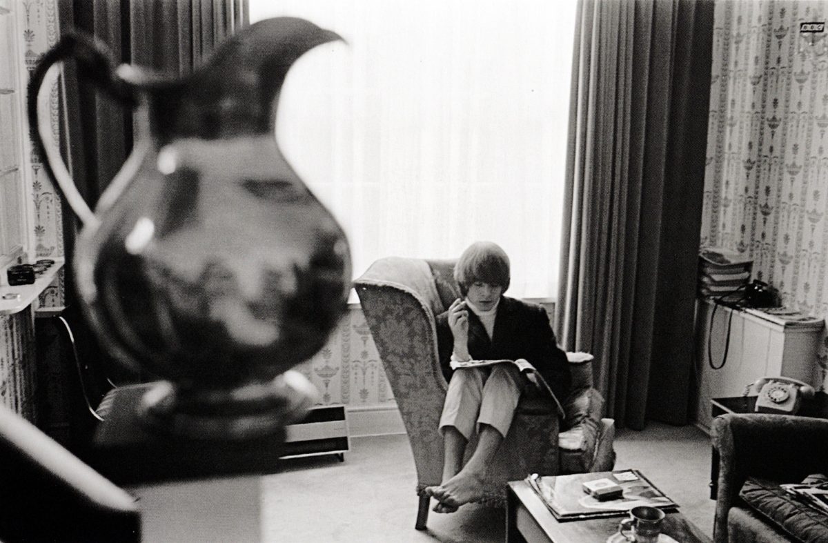 BJ sitting down reading in living room
